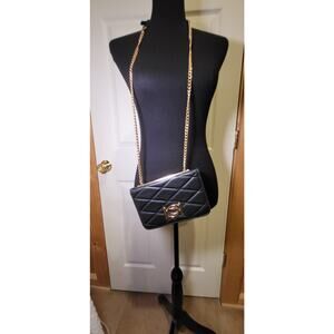 BeBe Crossbody purse, black, long gold color strap, divided sections.